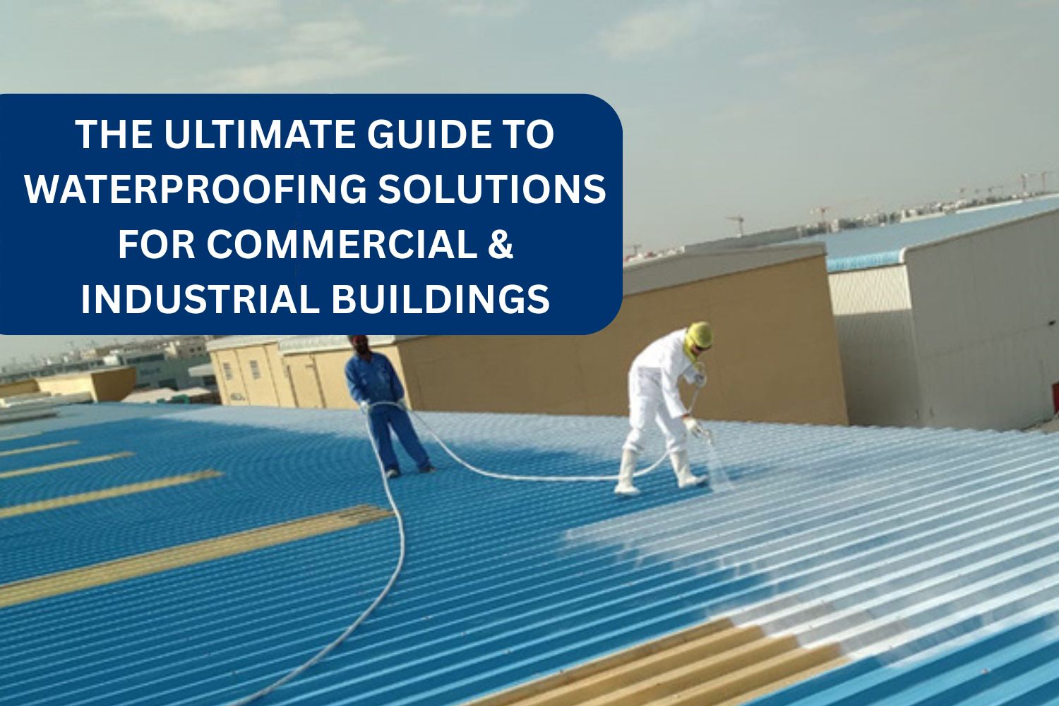 workers doing waterproofing on industrial building in UAE.